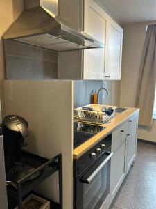 a kitchen with a stove top oven in a kitchen at Les petits nids de Nina 4 in Fosses-La-Ville +7 photos