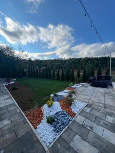 a backyard with a garden with rocks and trees at Pine Serenity Villa in Novoberdo