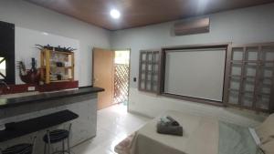 a living room with a large window and a fireplace at Villa São Lourenço in Bertioga +152 photos