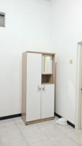a room with a white door and a cabinet at Rumah Sri Pasti in Jrebeng-wetan