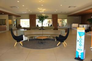a lobby with a table and chairs in a building at Praias do Lago Eco Resort - Central de Reservas in Caldas Novas +143 photos