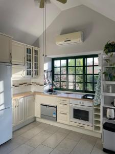 a kitchen with white cabinets and a white refrigerator at VV Sweet Flamboyan Playaflor 1 "by henrypole home" in Maspalomas
