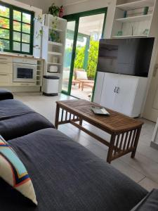 a living room with a couch and a coffee table at VV Sweet Flamboyan Playaflor 1 "by henrypole home" in Maspalomas