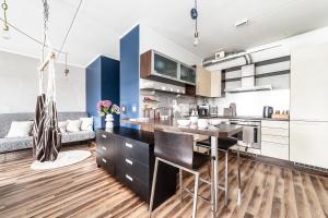 a kitchen with a large island in a room at Top floor near ferry terminal - free parking in Tallinn