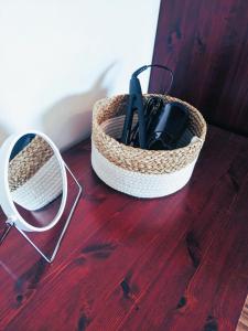 a basket on a wooden table next to a mirror at Top floor near ferry terminal - free parking in Tallinn