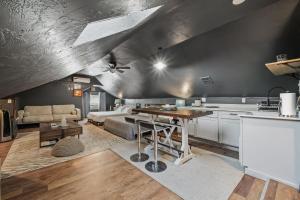 a kitchen and living room with a table and a couch at 5BR Home 10 mins Fair Park, Sleeps 14 in Oklahoma City