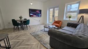 a living room with a couch and a table at Camden Market Properties in London
