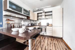 a large kitchen with a wooden counter top at Top floor near ferry terminal - free parking in Tallinn