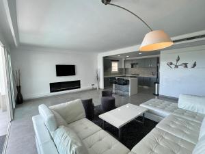 a living room with a white couch and a table at Meditranee Sea View in Tangier