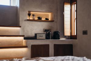 a kitchen with a counter with a coffee maker on it at Aethra Vegan Caves in Pyrgos
