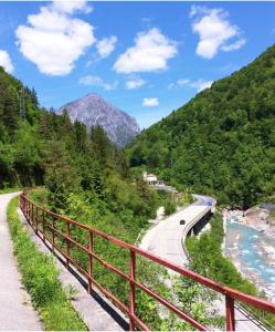 a red bridge over a road in the mountains at Zelda in Udine
