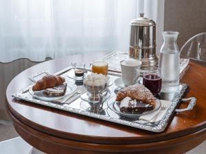 a tray of food on a table with desserts at Maison boutique Matteotti in Matera