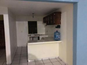 a kitchen with a bottle of water sitting on the counter at Habitacion llena de paz in Tonalá