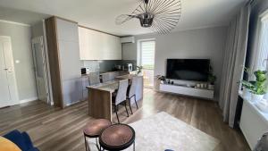 a kitchen and living room with a table and chairs at Apartament - U Alicji in Konin