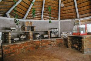a kitchen with a brick fireplace in a building at Yolandré in Rustenburg