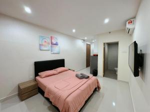 a bedroom with a pink bed and a television at Kuching Cozy Comfort 02 - Kozi Square Studio in Kuching +23 photos