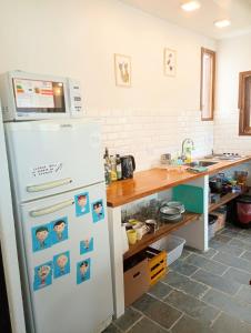 a kitchen with a refrigerator with magnets on it at Posada San Antonio in El Chalten