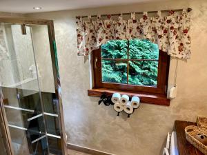 a bathroom with a window and rolls of toilet paper at Szczyrkowskie Historie in Szczyrk +30 photos