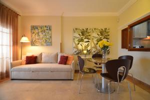 a living room with a couch and a table at Los Pelícanos SOLMARES in Isla Canela