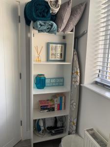 a book shelf in a room with books at Little Dene in Colyton