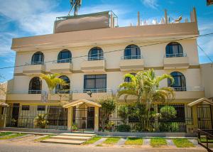 a large white building with trees in front of it at DEL VALLE HOUSE II in Ica