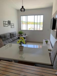 a living room with a table and a couch at Cantinho da day in Aracaju