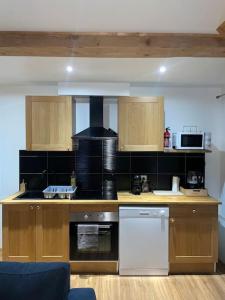 Una cocina con gabinetes de madera y un horno de estufa. en Maison du Tripot, en Ligny-en-Barrois 11 fotos más