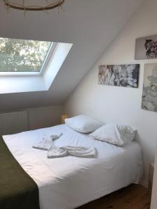 ein weißes Bett in einem Zimmer mit Fenster in der Unterkunft Bel Appartement Moderne TOP emplacement pour 4Pers et 2ch in Montigny-lès-Metz