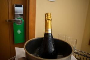 a bottle of champagne in a bucket on a table at Gloria Garden Suites in Macaé