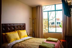 a bedroom with a bed and a large window at Del Valle House in Ica +225 photos