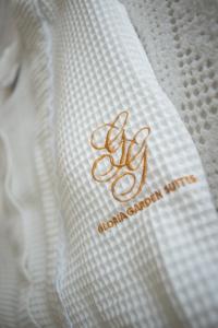 a close up of a white shirt with a gold logo at Gloria Garden Suites in Macaé