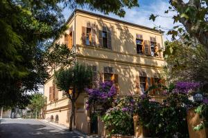 a building with purple flowers in front of it at Anthea Butik Otel in Adalar