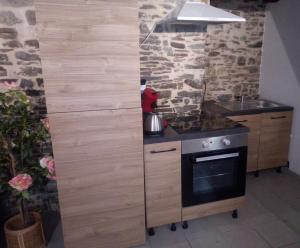 a small kitchen with a stove and a sink at NYNO DIGRABEN - House for Rent in Dol-de-Bretagne