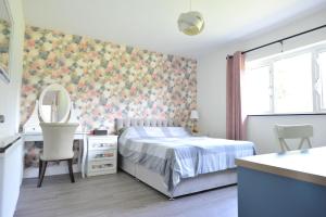 a bedroom with a bed and a dresser and a mirror at No 2 Willow Lodge in Dublin