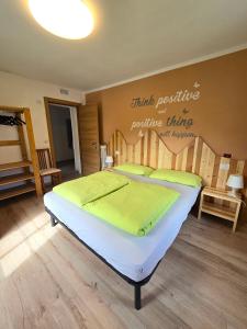 a bedroom with a bed with a sign on the wall at Appartamenti GG - Big and central in Livigno