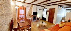 a living room with a table and a fireplace at La Casita de Benatae in Benatae