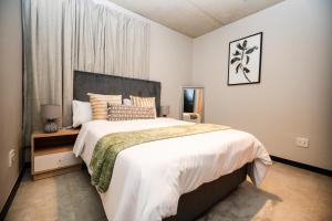 a bedroom with a large bed and a window at K47 propertyzz in Midrand +50 photos