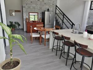 a kitchen and dining room with a sink and a table at Casa BOSQUE LUCIERNAGAS in Bacalar