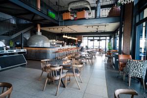 a restaurant with tables and chairs and a bar at K47 propertyzz in Midrand