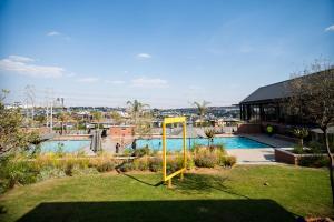 a yellow basketball hoop in the middle of a yard at K47 propertyzz in Midrand
