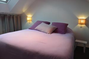 a bedroom with a bed with two pillows and two lights at Grand loft 110m Cœur historique Angers et parking privé Rare in Angers +11 photos