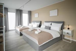 a bedroom with two beds with white towels on them at LaMiaCasa Green Large Loft City Close Green Area in Stuttgart