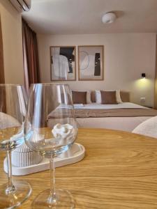 two wine glasses sitting on a table in a room at Luxury Apartments Stefano - Premium in Ohrid
