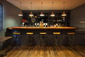 a bar with stools in a room at Sugar Bay Barbados - All Inclusive in Bridgetown