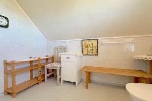 a room with a desk and a table and a bench at Lofoten midnight sun spot house on the beach in Eggum +8 photos