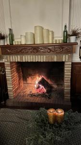a fireplace with candles on top of it at Casa rural La Esencia de Don Quijote in Bolaños de Calatrava