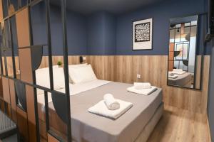 a small room with a bed and a bathroom at OMIKRON luxury living in Thessaloniki