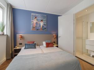 a bedroom with two beds and a painting on the wall at Villa in Zeeland near Clean Beaches in Colijnsplaat