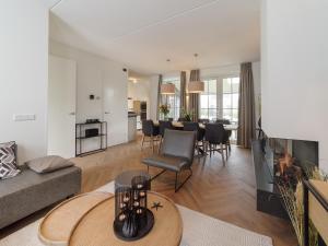 a living room with a couch and a table at Villa in Zeeland near Clean Beaches in Colijnsplaat