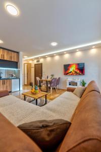 a living room with a couch and a table at Apartman Andjela12 Zlatibor in Ocka Gora